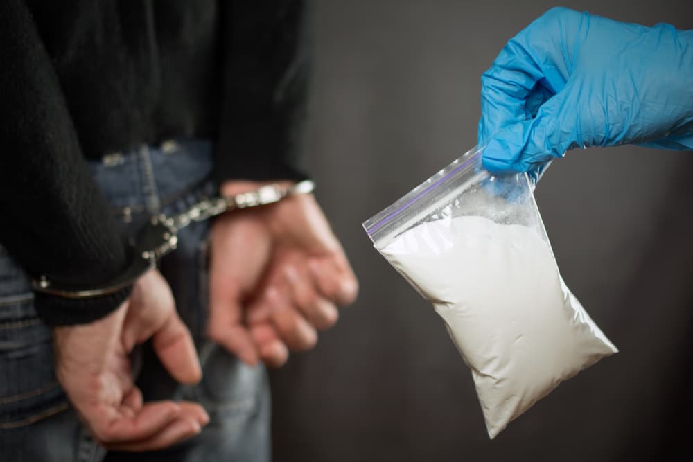 During a search, a police officer discovers illegal drugs in the possession of suspected drug dealers, indicating the unlawful transport of narcotics.