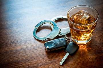 DWI Attorney glass of whiskey with car keys and handcuffs