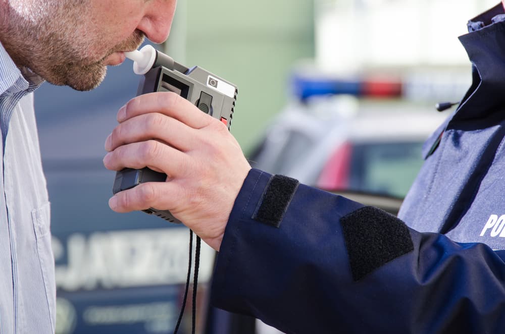 Policeman taking Breathalyzer Test of DWI driver