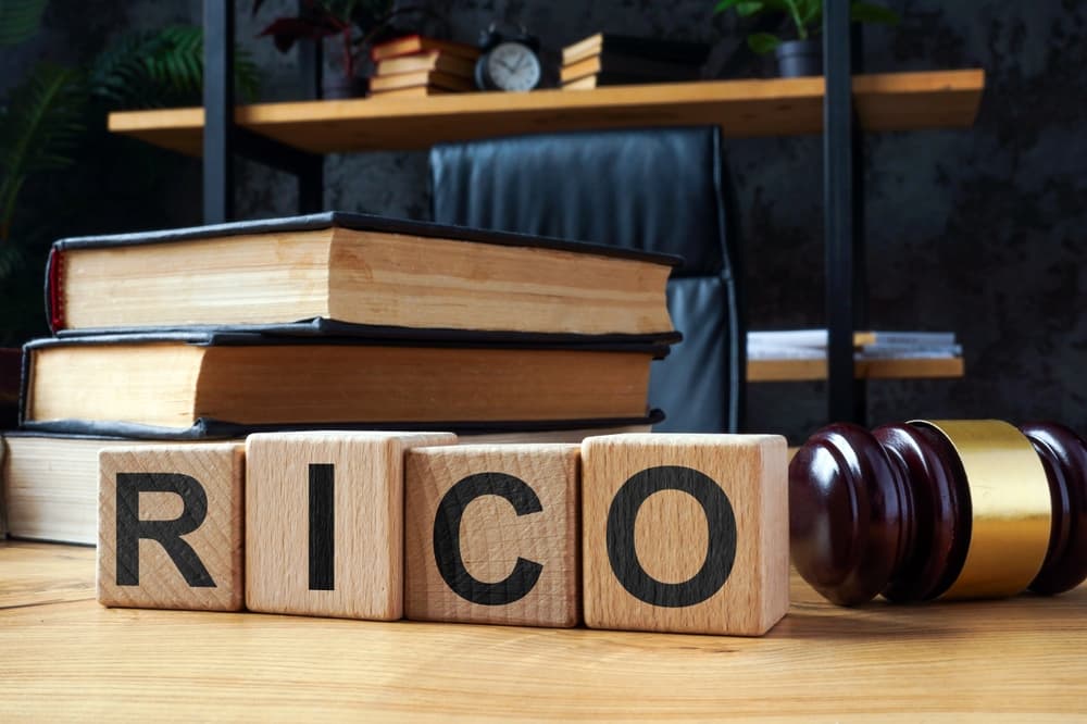 Cubes spelling out RICO (Racketeer Influenced and Corrupt Organizations Act) alongside a judge's gavel.